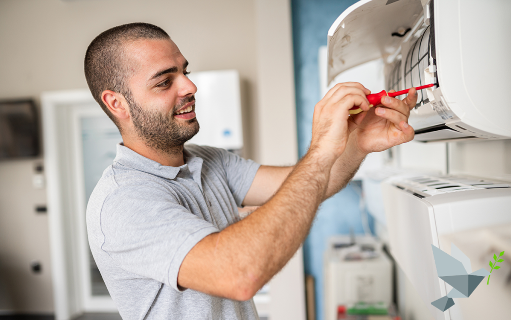 A technician replacing a ductless HVAC system