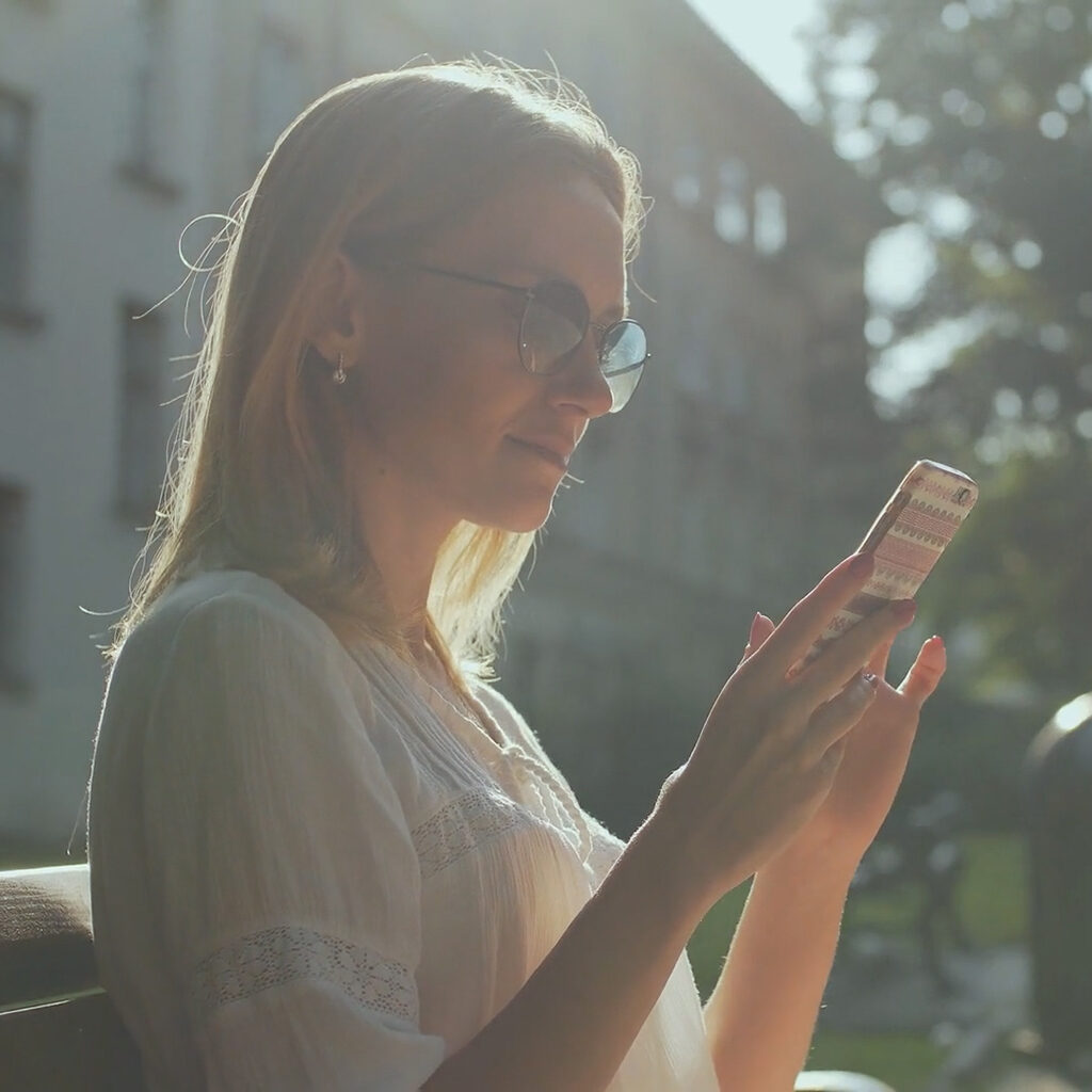 Are Wi-Fi Thermostats Cost-Effective? Girl setting thermostat from phone.